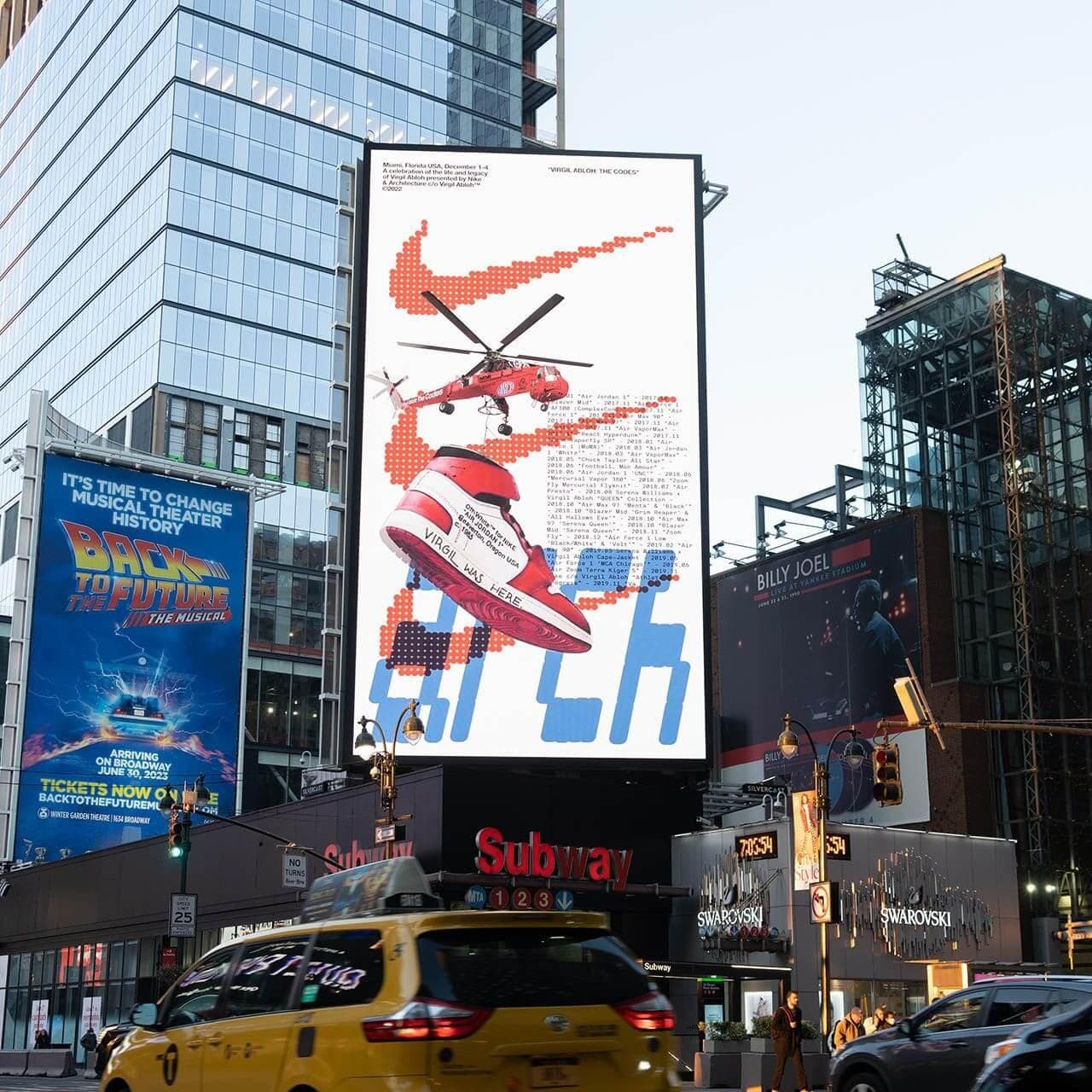 Archive image 3: A photo of a busy Times Square intersection at night, with bright, towering digital billboards.